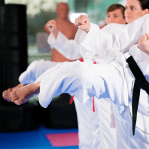 A group of people in white uniforms practicing karate.